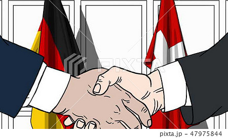 Businessmen or politicians shaking hands against flags of Germany and Switzerland. Meeting or Businessmen or politicians shaking hands against flags of Germany and Switzerland. Meeting or 47975844