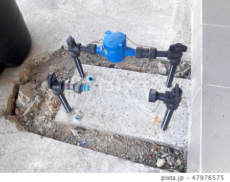 Water pipe and meter with waterspout on the floor. 47976575
