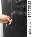 Man open the door of computer server rack 47976582