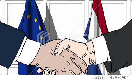 Businessmen or politicians shaking hands against flags of EU and Netherlands. Meeting or cooperation 47976904