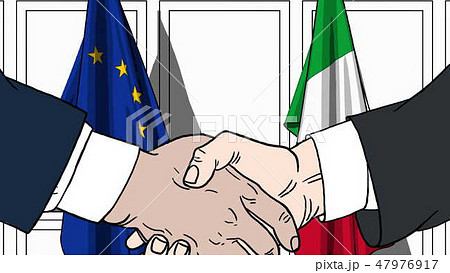 Businessmen or politicians shaking hands against flags of EU and Italy. Meeting or cooperation Businessmen or politicians shaking hands against flags of EU and Italy. Meeting or cooperation 47976917