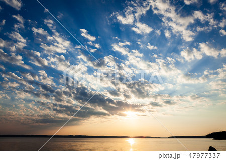 Clouds and sunrays at sunrise 47977337
