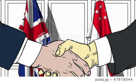 Businessmen or politicians shake hands against flags of Britain and Singapore. Official meeting or 47978044