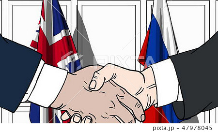 Businessmen or politicians shaking hands against flags of Great Britain and Russia. Meeting or 47978045