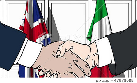 Businessmen or politicians shaking hands against flags of Great Britain and Italy. Meeting or Businessmen or politicians shaking hands against flags of Great Britain and Italy. Meeting or 47978089