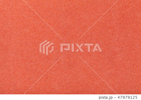 Dark orange matt suede fabric closeup. Velvet felt 47979125