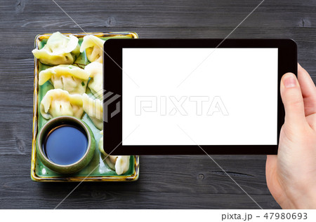 Dumplings on plate on dark table with copyspace 47980693