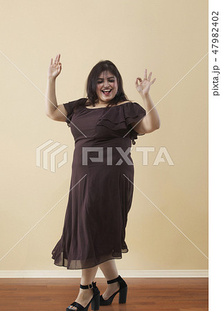 Fat woman dancing on high heels 47982402
