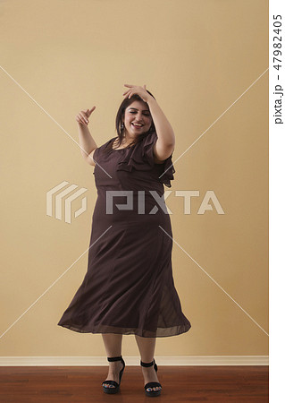 Fat woman dancing on high heels 47982405