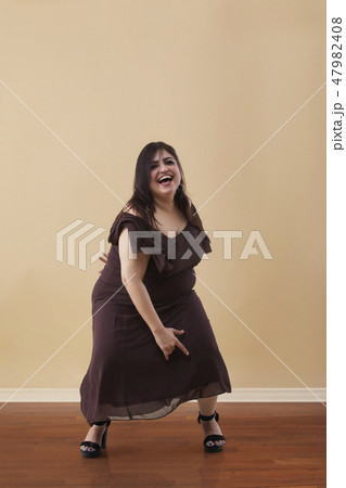 Fat woman dancing on high heels Fat woman dancing on high heels 47982408