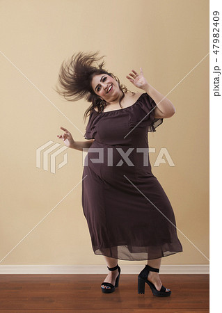 Fat woman dancing on high heels 47982409
