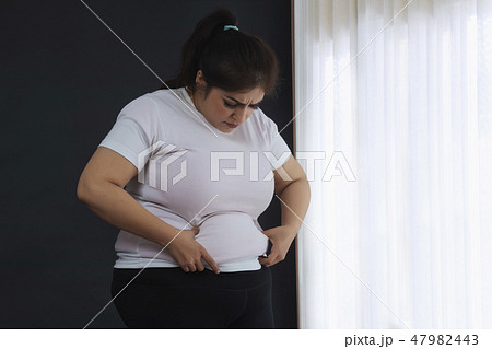 Woman Holding His Belly Fat With Both Hands 47982443