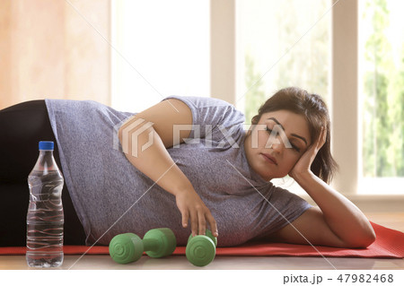 woman lying down on the floor woman lying down on the floor 47982468