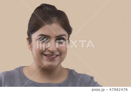 Smiling overweight woman looking away 47982476