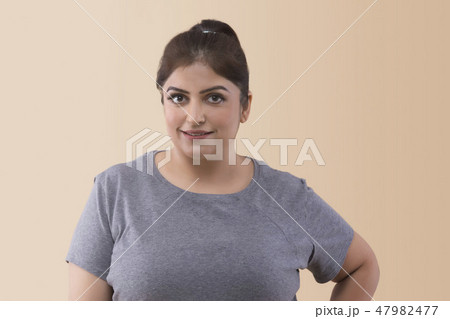 Smiling overweight woman looking at the camera 47982477