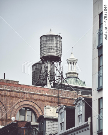 Water tanks on a roof of a building in New York. 47982844