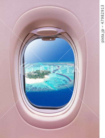 Airplane window view of Maldives island 47982913