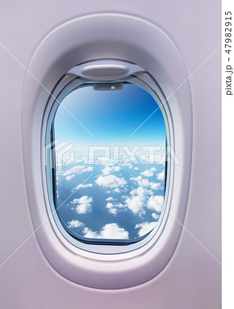Airplane interior with window view of clouds. 47982915