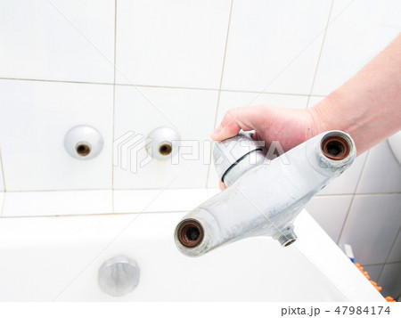 Plumber holding a dual outlet shower faucet Plumber holding a dual outlet shower faucet 47984174