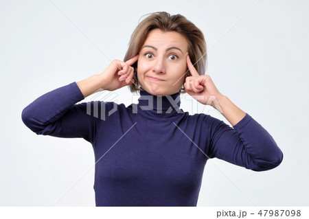 Woman generates new idea in mind, looks thoughtfully Woman generates new idea in mind, looks thoughtfully 47987098