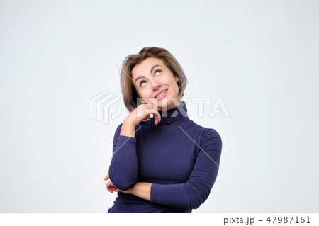 Woman thinking about thing she desire with intrigued and interested expression Woman thinking about thing she desire with intrigued and interested expression 47987161
