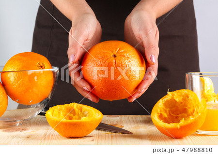 girl preparing fresh citrus juice girl preparing fresh citrus juice 47988810