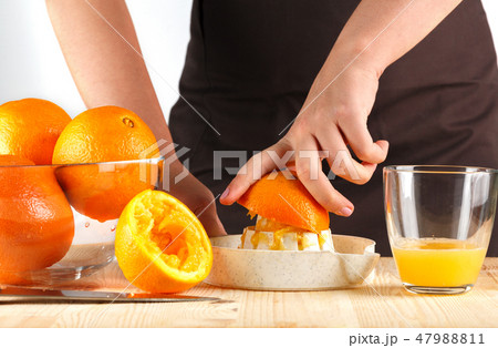 girl preparing fresh citrus juice girl preparing fresh citrus juice 47988811