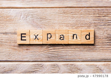 EXPAND word written on wood block. EXPAND word written on wood block. 47990178