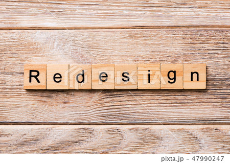 REDESIGN word written on wood block. REDESIGN word written on wood block. 47990247