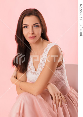 charming woman in pink lush skirt on pink background. charming woman in pink lush skirt on pink background. 47990779