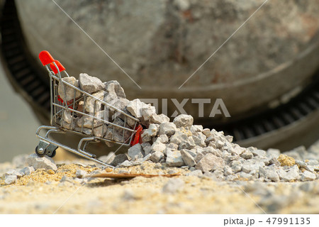 Shopping trolley stands on the pile of stone 47991135