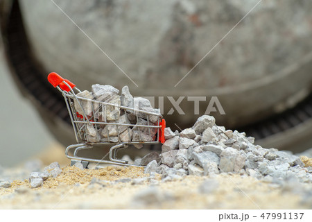 Shopping trolley stands on the pile of stone Shopping trolley stands on the pile of stone 47991137