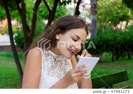 Woman is writing down her exciting ideas Woman is writing down her exciting ideas 47991273