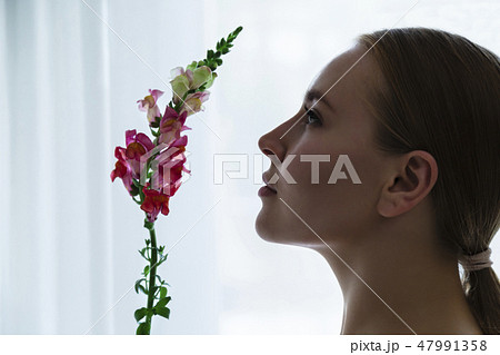 beautiful blond woman with snapdragon flower 47991358