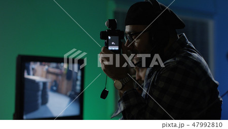 Young director giving instructions on a film set 47992810