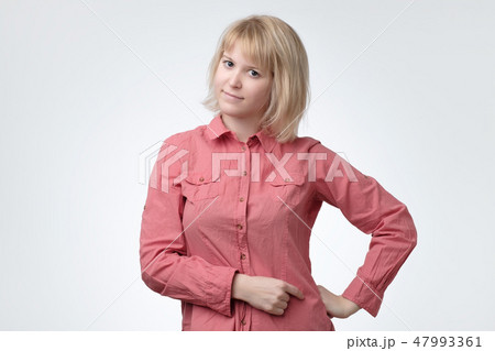 Teenage girl with blonde hair having fun indoors and looking at camera with cheerful smile. Teenage girl with blonde hair having fun indoors and looking at camera with cheerful smile. 47993361