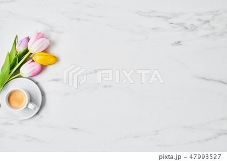 Cup of coffee with tulips Cup of coffee with tulips 47993527