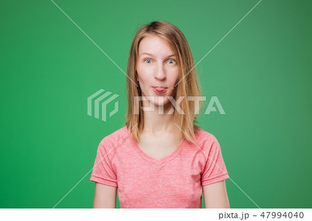 close up of funny european woman showing tongue close up of funny european woman showing tongue 47994040