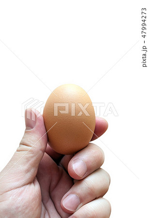 Hand holding an egg isolated on white background 47994273