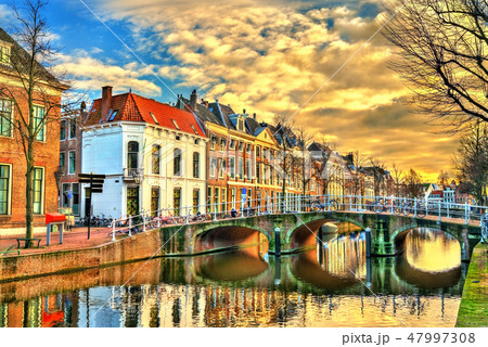 The Doelenbrug bridge across a canal in Leiden, the Netherlands 47997308