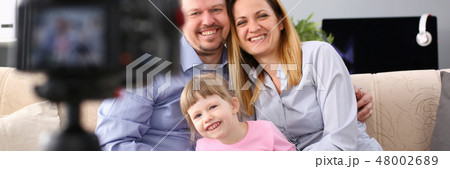 Happy adult millenial family photographed Happy adult millenial family photographed 48002689
