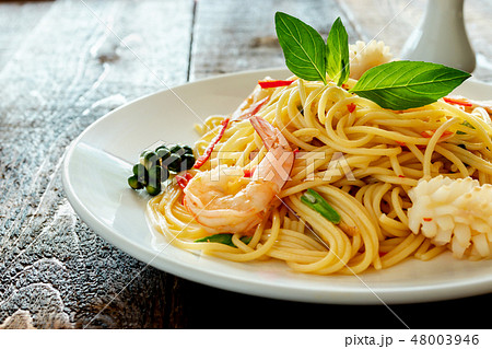 spicy spaghetti with seafood on plate. 48003946