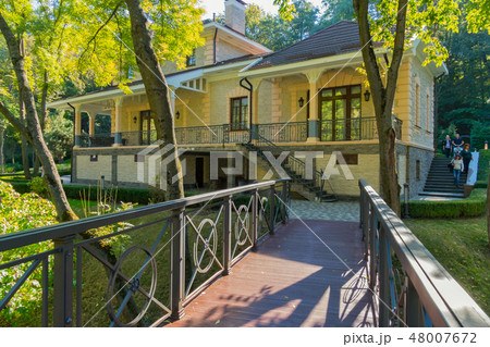 A wooden bridge leading to the house with a stairc A wooden bridge leading to the house with a stairc 48007672