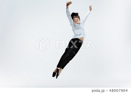 Happy business woman dancing and smiling isolated on white. Happy business woman dancing and smiling isolated on white. 48007904