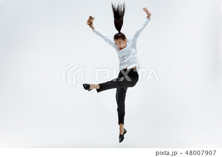 Happy business woman dancing and smiling isolated on white. 48007907