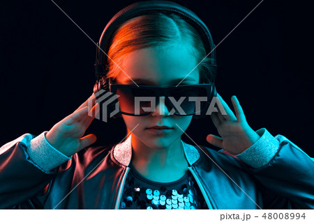 Young girl with headphones enjoying music 48008994