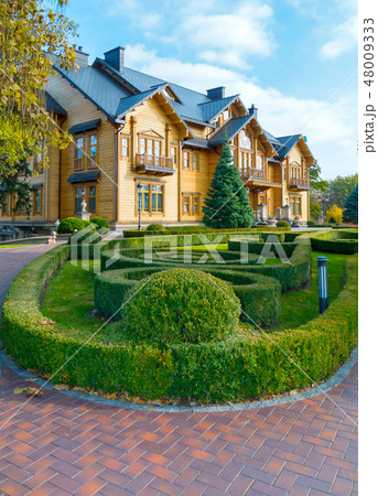 A flowerbed with a labyrinth of green bushes near A flowerbed with a labyrinth of green bushes near 48009333