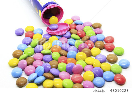 Multicolored candies out of the container Multicolored candies out of the container 48010223