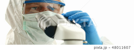 Male chemist in blue protective gloves look Male chemist in blue protective gloves look 48011607