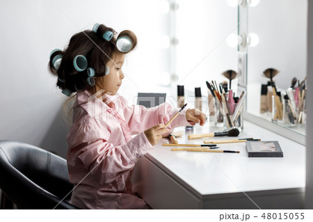 Cute little girl playing with her mother's cosmetic 48015055
